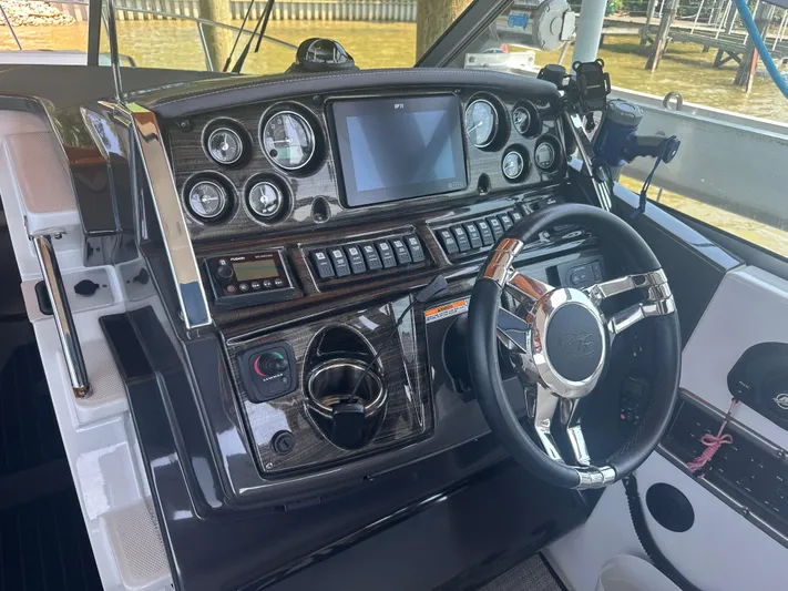 Always Flo&rsquo;n Yacht Photos Pics 2019 Monterey 295 Sport Yacht dashboard with steering wheel and control panel.