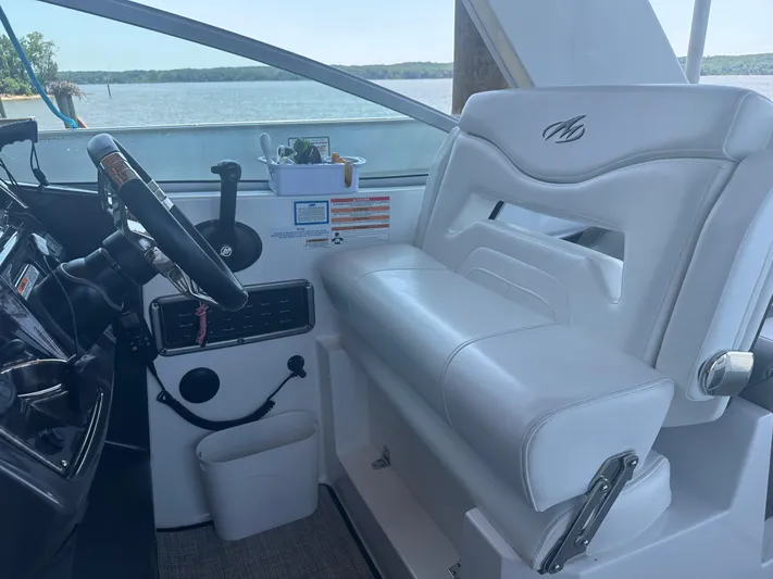 Always Flo&rsquo;n Yacht Photos Pics 2019 Monterey 295 Sport Yacht helm with white seating and steering wheel, overlooking water.