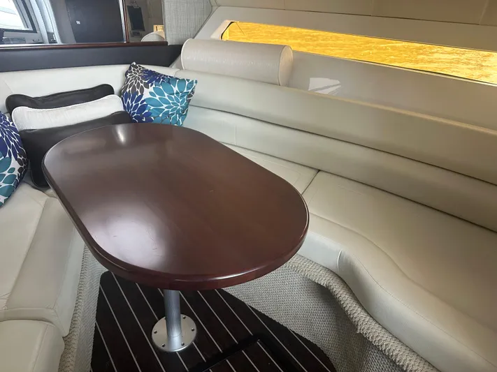 Always Flo&rsquo;n Yacht Photos Pics Interior of 2019 Monterey 295 Sport Yacht with elegant seating and wooden table.