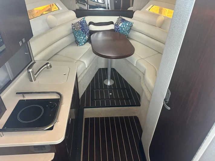 Always Flo&rsquo;n Yacht Photos Pics 2019 Monterey 295 Sport Yacht interior with kitchenette, seating, and table.