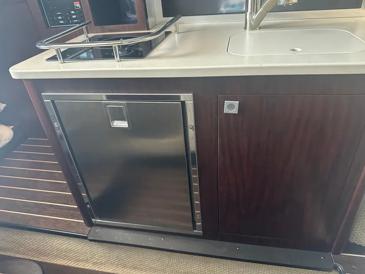 Always Flo&rsquo;n Yacht Photos Pics 2019 Monterey 295 Sport Yacht kitchen area with sink and stainless steel fridge.
