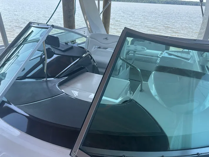 Always Flo&rsquo;n Yacht Photos Pics 2019 Monterey 295 Sport Yacht interior with windshield and seating, docked by the water.
