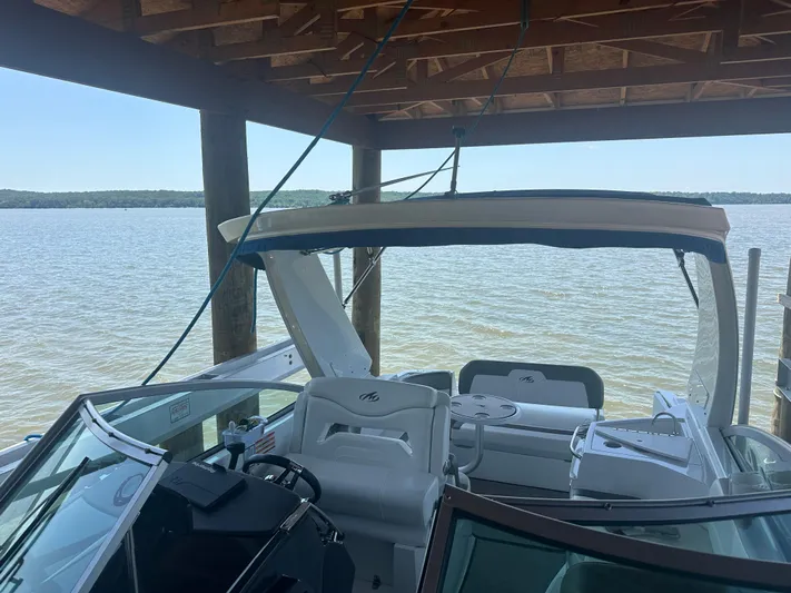 Always Flo&rsquo;n Yacht Photos Pics 2019 Monterey 295 Sport Yacht docked under a wooden shelter on a calm lake.