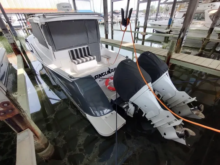 Singularity Yacht Photos Pics True North 34 boat, 2022 model, docked with twin outboard engines in a marina.