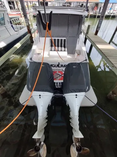 Singularity Yacht Photos Pics True North 34 boat, 2022 model, docked with dual outboard motors.