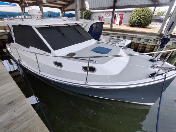 Singularity Yacht Photos Pics 2022 True North 34 boat docked in a marina, featuring sleek design and modern amenities.