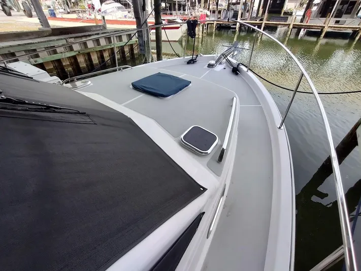 Singularity Yacht Photos Pics 2022 True North 34 boat docked, showcasing sleek deck design and railing.