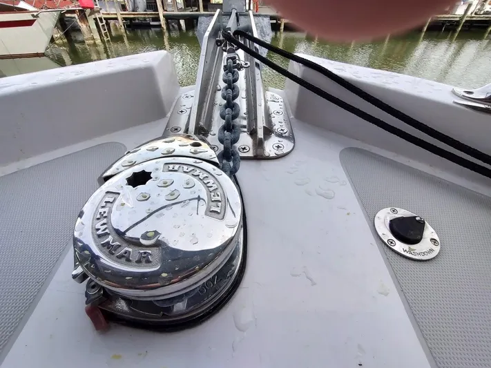 Singularity Yacht Photos Pics Close-up of a 2022 True North 34 boat's anchor windlass and chain on deck.