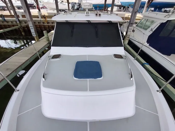 Singularity Yacht Photos Pics 2022 True North 34 boat docked, featuring a sleek deck and modern design.