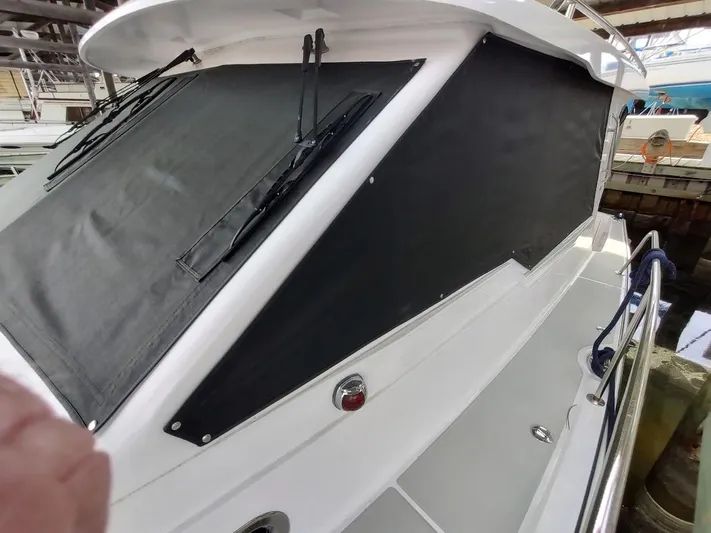 Singularity Yacht Photos Pics 2022 True North 34 boat with black window covers and sleek white exterior.