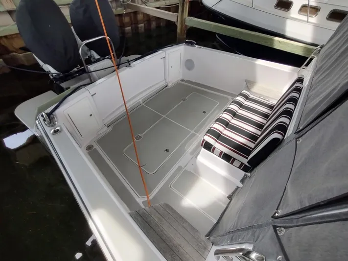 Singularity Yacht Photos Pics 2022 True North 34 boat interior with striped seating and spacious deck area.