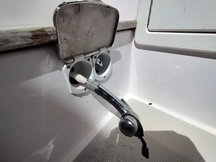 Singularity Yacht Photos Pics Outdoor shower fixture on a 2022 True North 34 boat, with water hose and nozzle.