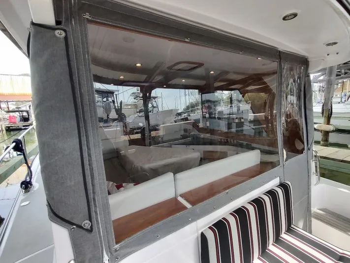 Singularity Yacht Photos Pics Interior view of 2022 True North 34 boat with seating and clear enclosure.