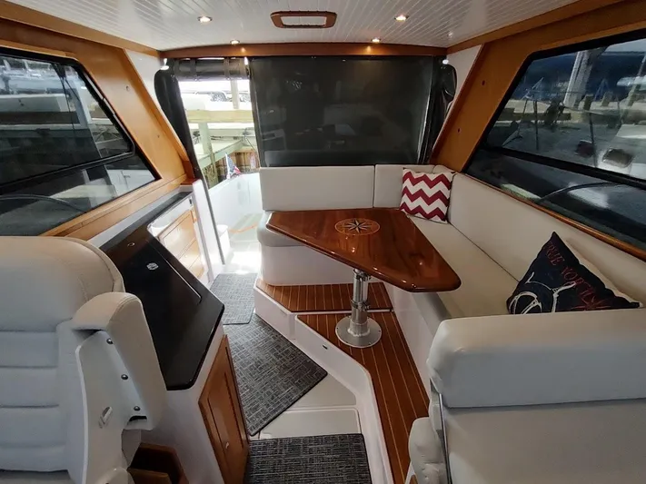 Singularity Yacht Photos Pics Luxurious interior of 2022 True North 34 yacht with elegant seating and wooden table.
