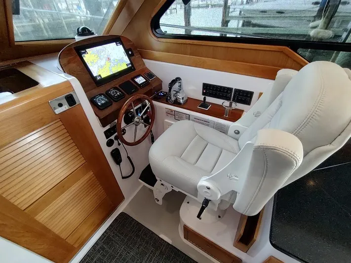 Singularity Yacht Photos Pics Luxurious 2022 True North 34 boat cockpit with navigation system and plush captain's chair.