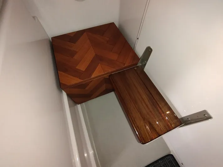 Singularity Yacht Photos Pics Wooden step with herringbone pattern in a 2022 True North 34 boat interior.