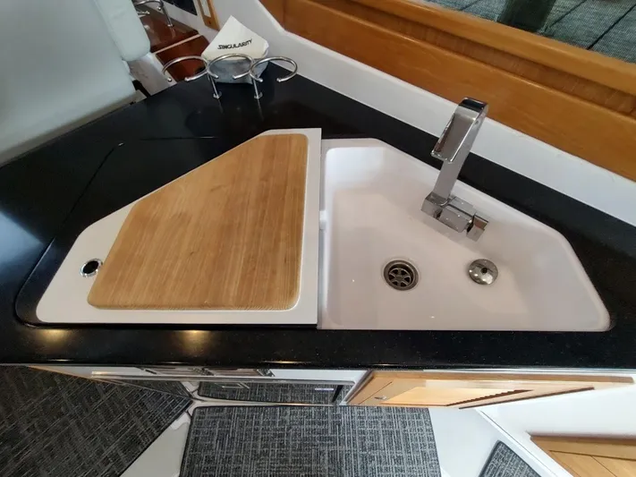 Singularity Yacht Photos Pics Modern kitchen sink with wooden cutting board in 2022 True North 34 boat.