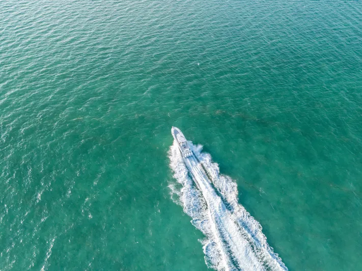  Yacht Photos Pics Aerial view of 2023 Front Runner 39 Center Console boat cruising on turquoise water.