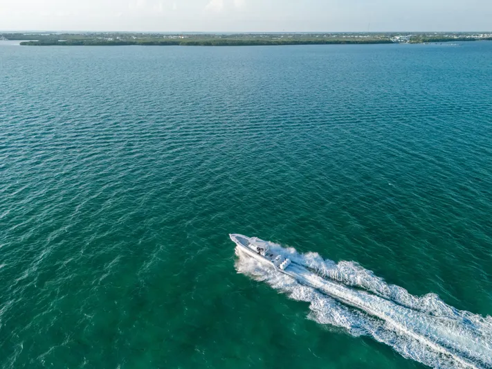  Yacht Photos Pics Aerial view of 2023 Front Runner 39 Center Console speeding on open water.