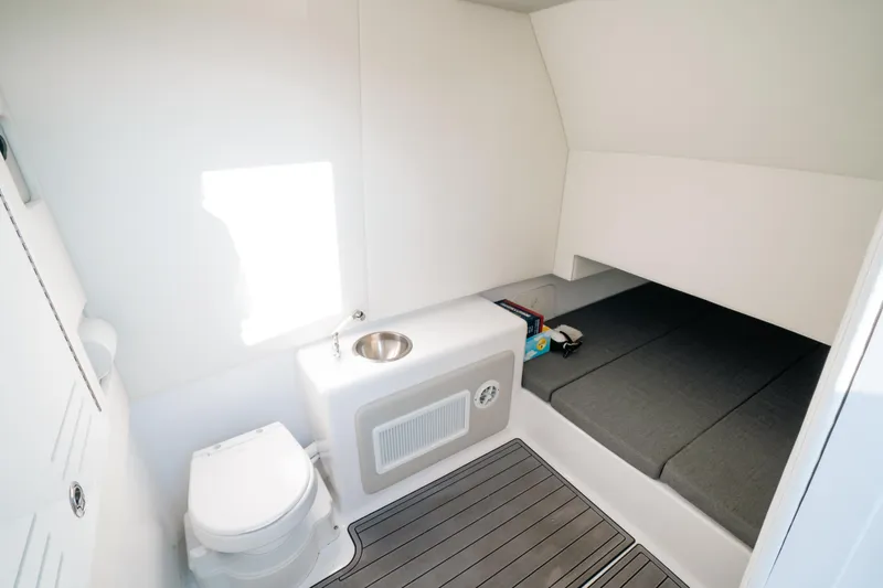  Yacht Photos Pics 2023 Front Runner 39 Center Console cabin with toilet, sink, and sleeping area.