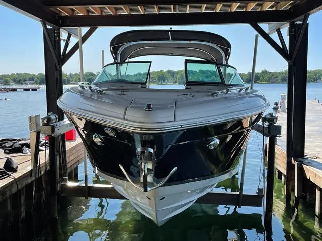  Yacht Photos Pics 2016 Regal 3200 Bowrider boat docked on a lift by a scenic lake.