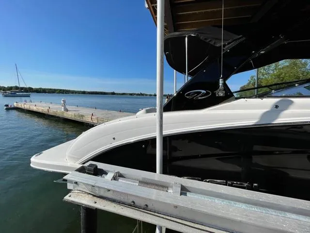 Yacht Photos Pics 2016 Regal 3200 Bowrider docked by a serene lake with clear blue skies.