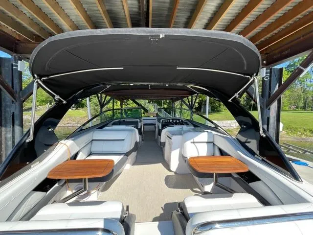  Yacht Photos Pics 2016 Regal 3200 Bowrider boat interior with seating and tables under a canopy.