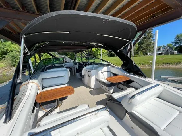  Yacht Photos Pics 2016 Regal 3200 Bowrider boat interior with seating and tables under canopy.