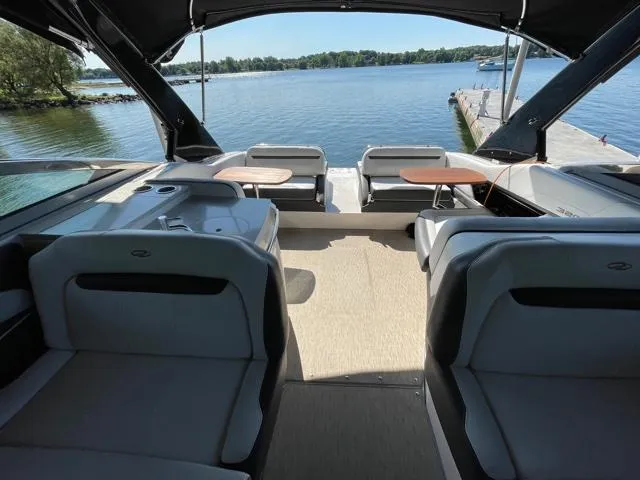  Yacht Photos Pics 2016 Regal 3200 Bowrider interior with lake view, featuring comfortable seating and sleek design.