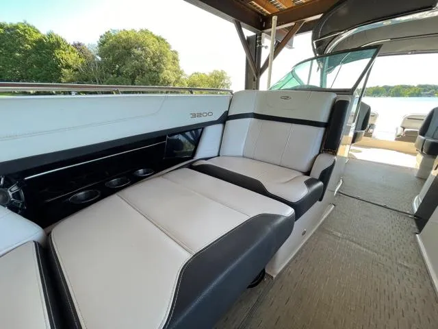  Yacht Photos Pics 2016 Regal 3200 Bowrider interior with luxurious seating and cup holders, docked by a lake.