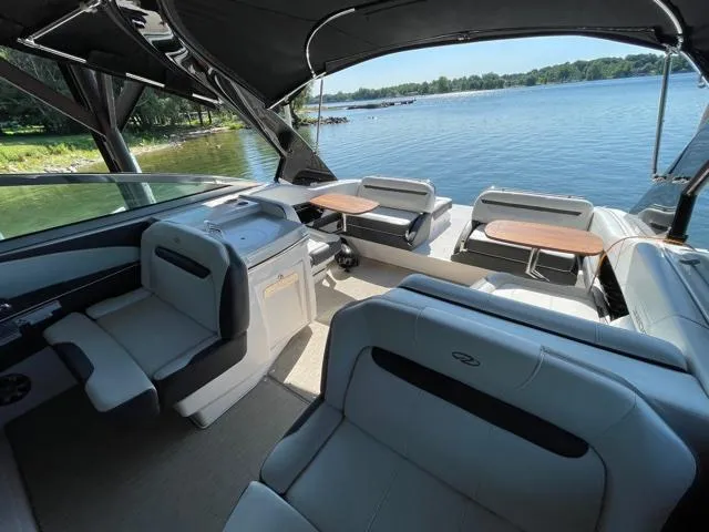  Yacht Photos Pics 2016 Regal 3200 Bowrider interior with seating, tables, and lake view.