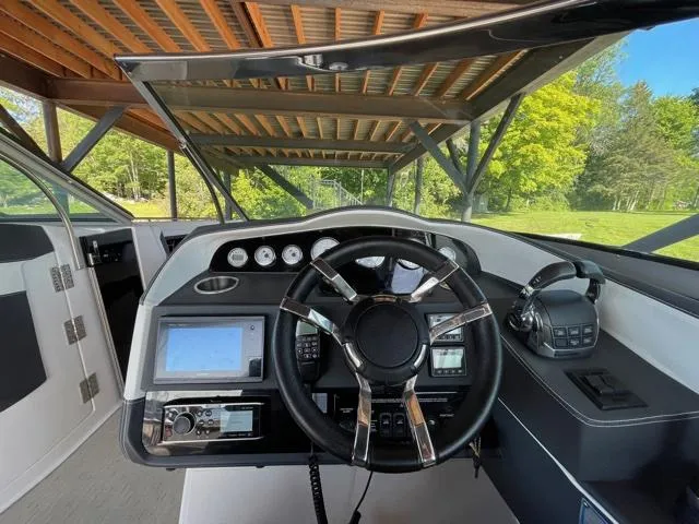 Yacht Photos Pics Cockpit of 2016 Regal 3200 Bowrider boat with steering wheel and navigation controls.