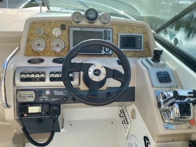  Yacht Photos Pics Control panel of a 2010 Formula 350 Sun Sport boat with steering wheel and navigation instruments.