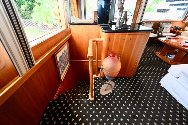 Captivator Yacht Photos Pics Luxurious interior of a 1984 Palmer Johnson motor yacht with elegant wood finishes.