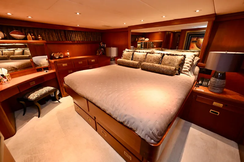 Captivator Yacht Photos Pics Luxurious bedroom interior of 1984 Palmer Johnson Motor Yacht with elegant wood furnishings.