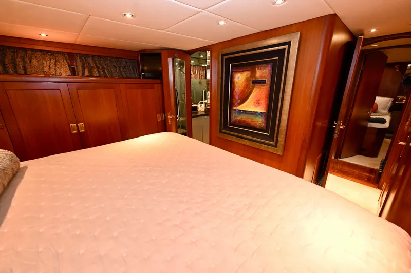 Captivator Yacht Photos Pics Luxurious 1984 Palmer Johnson motor yacht bedroom with elegant wood paneling and modern artwork.