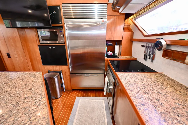 Captivator Yacht Photos Pics Luxurious 1984 Palmer Johnson motor yacht kitchen with modern appliances and granite countertops.