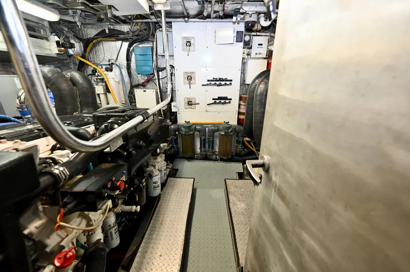 Captivator Yacht Photos Pics Engine room of a 1984 Palmer Johnson Motor Yacht, showcasing machinery and control panels.