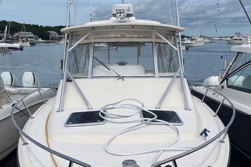  Yacht Photos Pics 2009 Grady-White Express 330 boat docked in a marina, surrounded by other vessels.