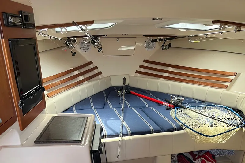  Yacht Photos Pics 2009 Grady-White Express 330 cabin interior with fishing gear and cozy seating.