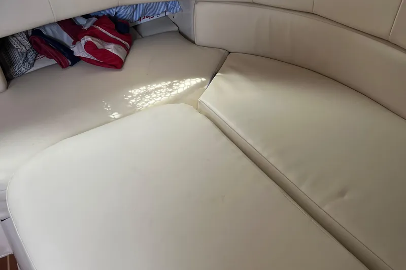  Yacht Photos Pics 2009 Grady-White Express 330 cabin interior with beige seating and storage area.