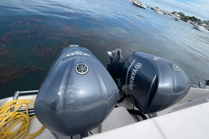  Yacht Photos Pics Twin Yamaha outboard engines on a 2009 Grady-White Express 330 boat, docked by the water.