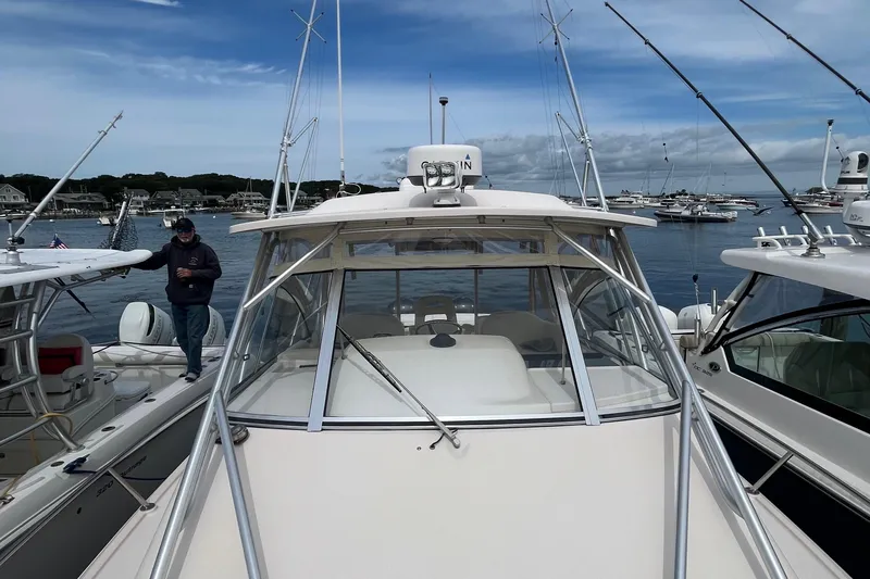  Yacht Photos Pics 2009 Grady-White Express 330 boat docked in a marina, surrounded by other vessels.