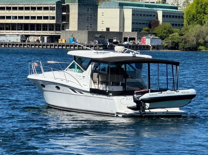 Rhumb Line Yacht Photos Pics 2000 Tiara Sport 3500 Open boat on water near industrial buildings.