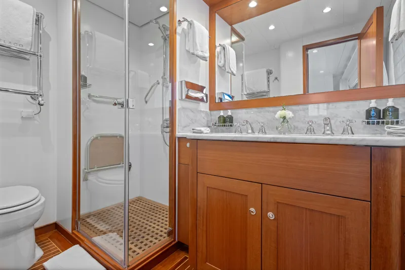 Archipelago Yacht Photos Pics Luxurious bathroom on 2005 Moonen Displacement Yacht with wooden cabinetry and glass shower.