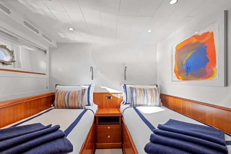 Archipelago Yacht Photos Pics Luxurious twin cabin on 2005 Moonen Displacement Yacht with modern decor and vibrant artwork.