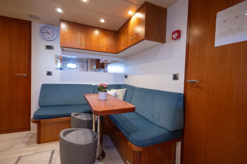 Archipelago Yacht Photos Pics Cozy interior of 2005 Moonen Displacement Yacht with blue seating and wooden accents.
