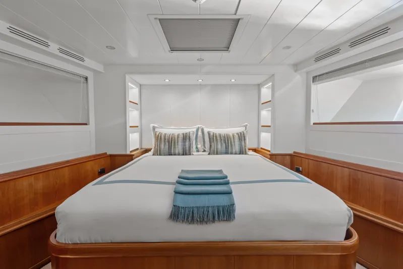 Archipelago Yacht Photos Pics Luxurious bedroom interior on 2005 Moonen Displacement Yacht, featuring elegant wood paneling and plush bedding.