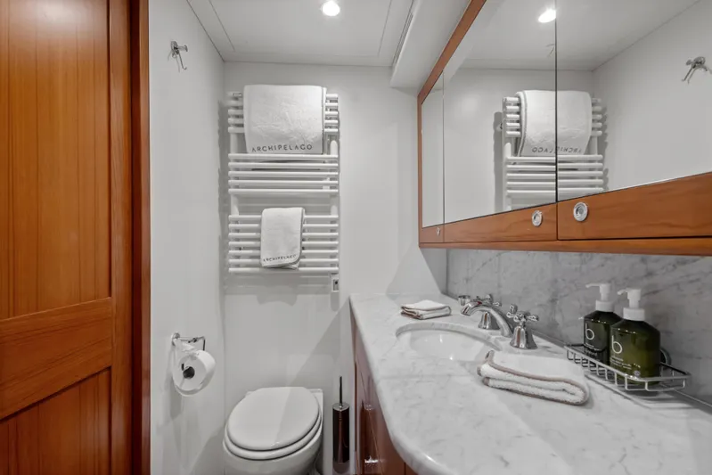 Archipelago Yacht Photos Pics Luxurious bathroom in 2005 Moonen Displacement Yacht with marble countertop and wooden accents.