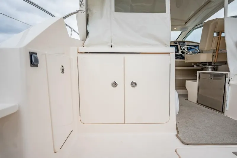 Scrappy G Yacht Photos Pics 2015 Pursuit SC 365i Sport Coupe interior with white cabinetry and seating area.